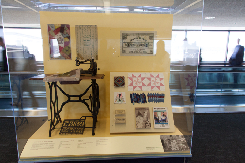 Image: Installation view of "Threading the Needle: Sewing in the Machine Age"