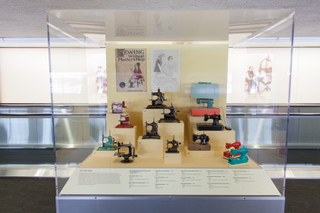 Image: Installation view of "Threading the Needle: Sewing in the Machine Age"