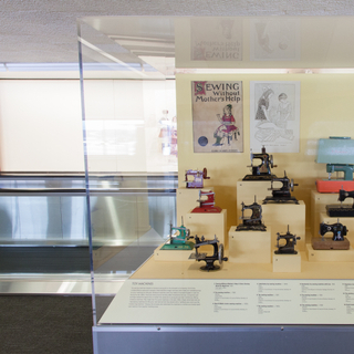 Installation view of "Threading the Needle: Sewing in the Machine Age"