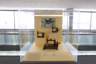 Image: Installation view of "Threading the Needle: Sewing in the Machine Age"