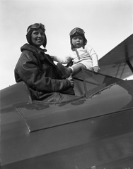 Image: negative: San Francisco Airport, woman pilot and child