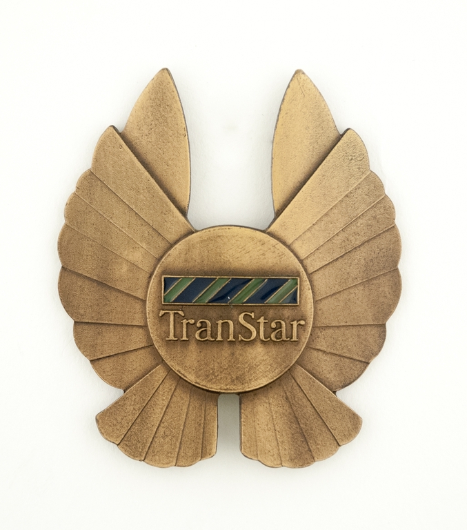 Objects | flight officer cap badge: TranStar Airlines | SFO Museum