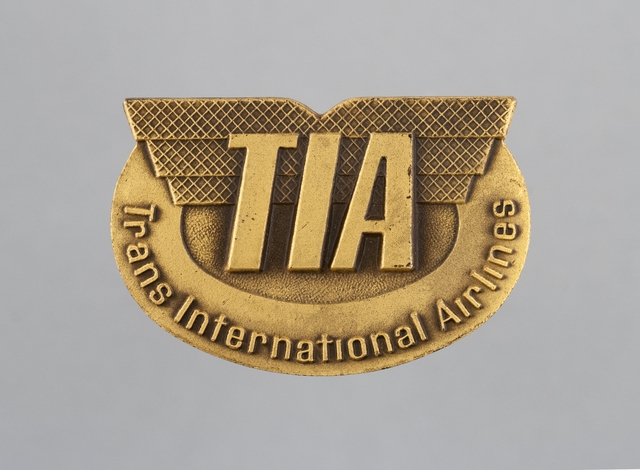 Ground crew hat badge: TIA (Trans International Airlines)