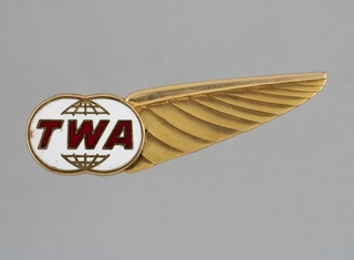 Image: air hostess hat badge: TWA (Trans World Airlines)