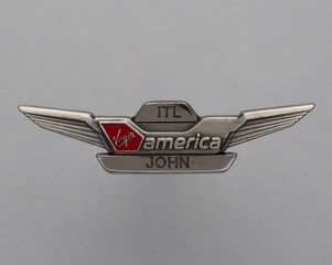 Image: flight attendant wing and name pin: Virgin America, John