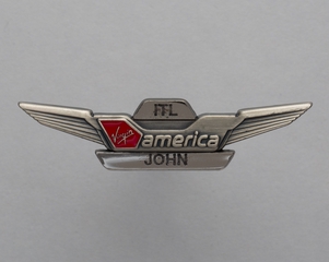 Image: flight attendant wing and name pin: Virgin America, John