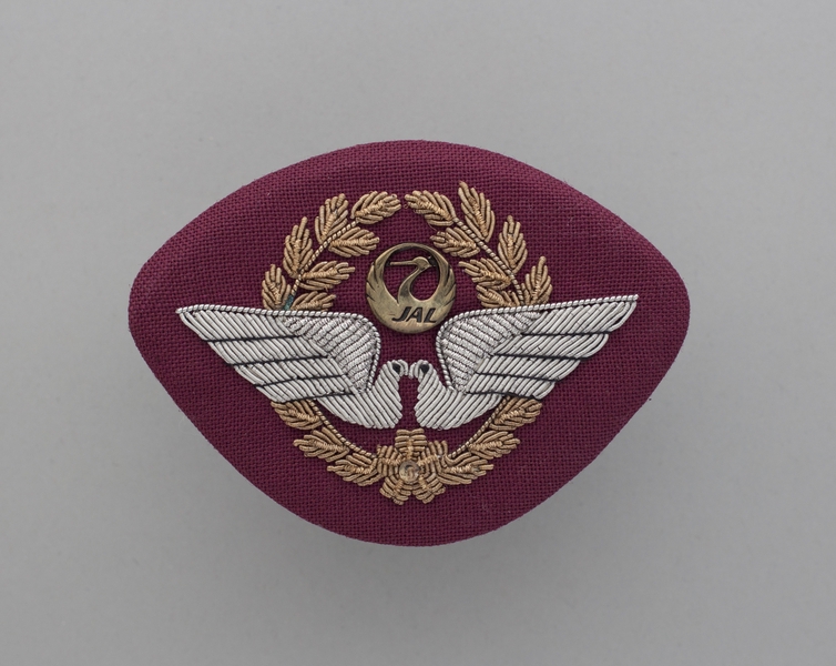 Image: flight officer cap badge: JAL Cargo (Japan Airlines)