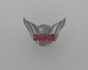 Image: gate agent hat badge: TWA (Trans World Airlines)
