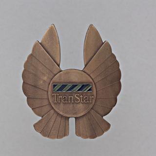 Objects | flight officer cap badge: TranStar Airlines | SFO Museum