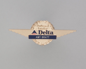 Image: flight attendant wings and name pin: Delta Air Lines, Amy Bratt