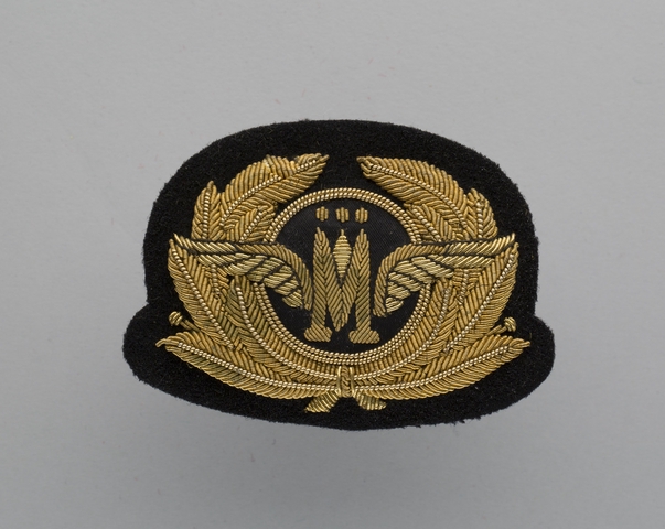 Flight officer cap badge: Monarch Airlines