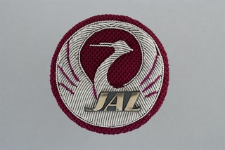 Image: service crew cap badge: Japan Airlines, cargo agent 