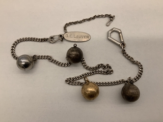 Image: necklace with four lawn bowling charms: Pan American Airways