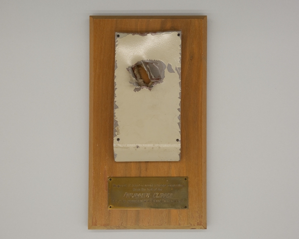 Plaque: Philippine Clipper fragment with .50 caliber bullet