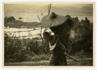 Image: photograph: man carrying basket