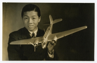 Image: photograph: man with model of Glenn Martin 139 WH-3